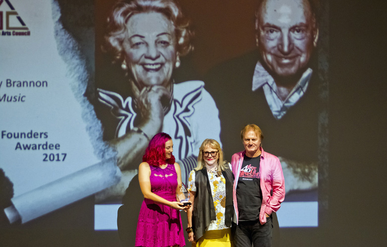 Arts Council member Hannah Collins presenting the Founders Award for Terry Brannon (deceased) to his children
